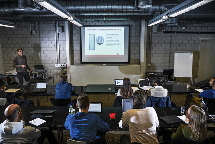 A group of people sitting at desks in a classroom