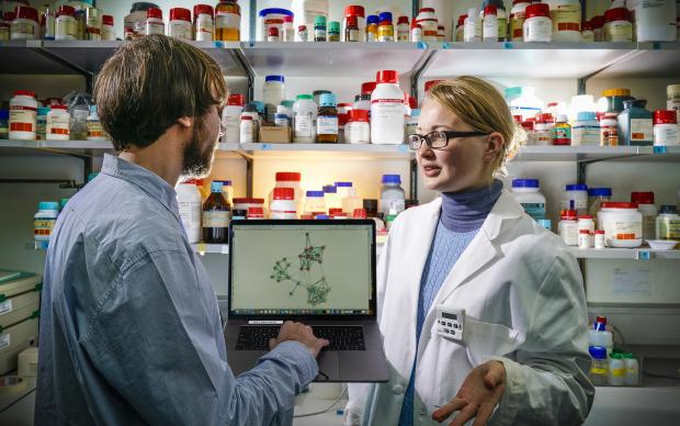 a man and woman in a lab talking to each other