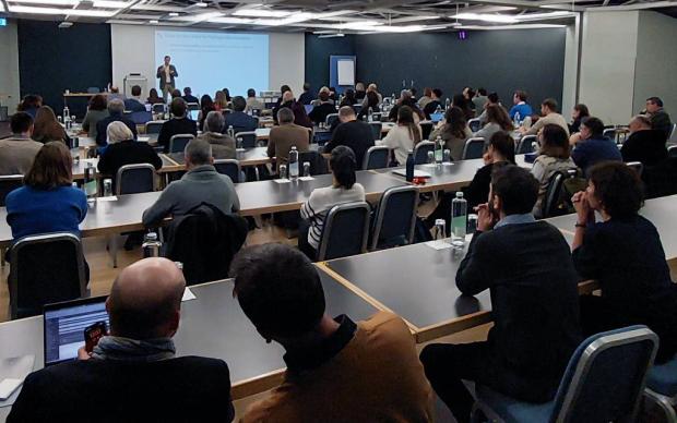 Room of people attending a symposium