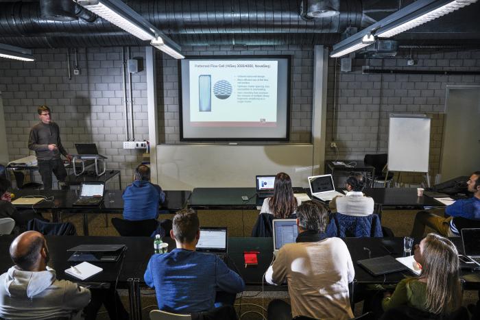 A group of people sitting at desks in a classroom