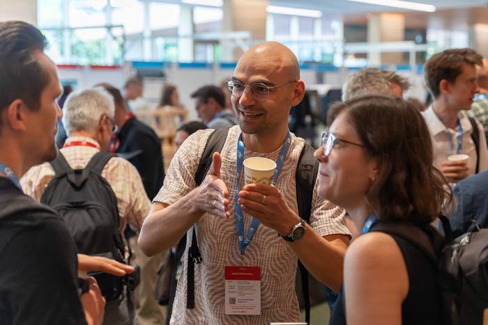 People talking at a scientific conference