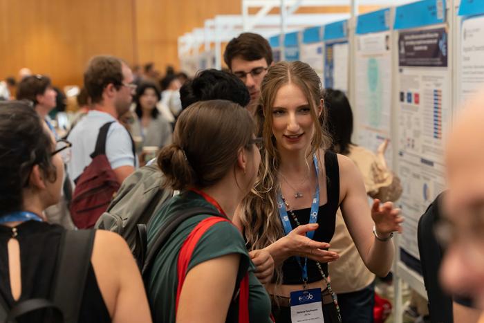 People talking in front of scientific posters at a conference