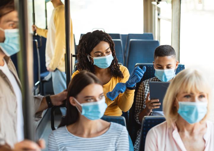People on a bus wearing masks